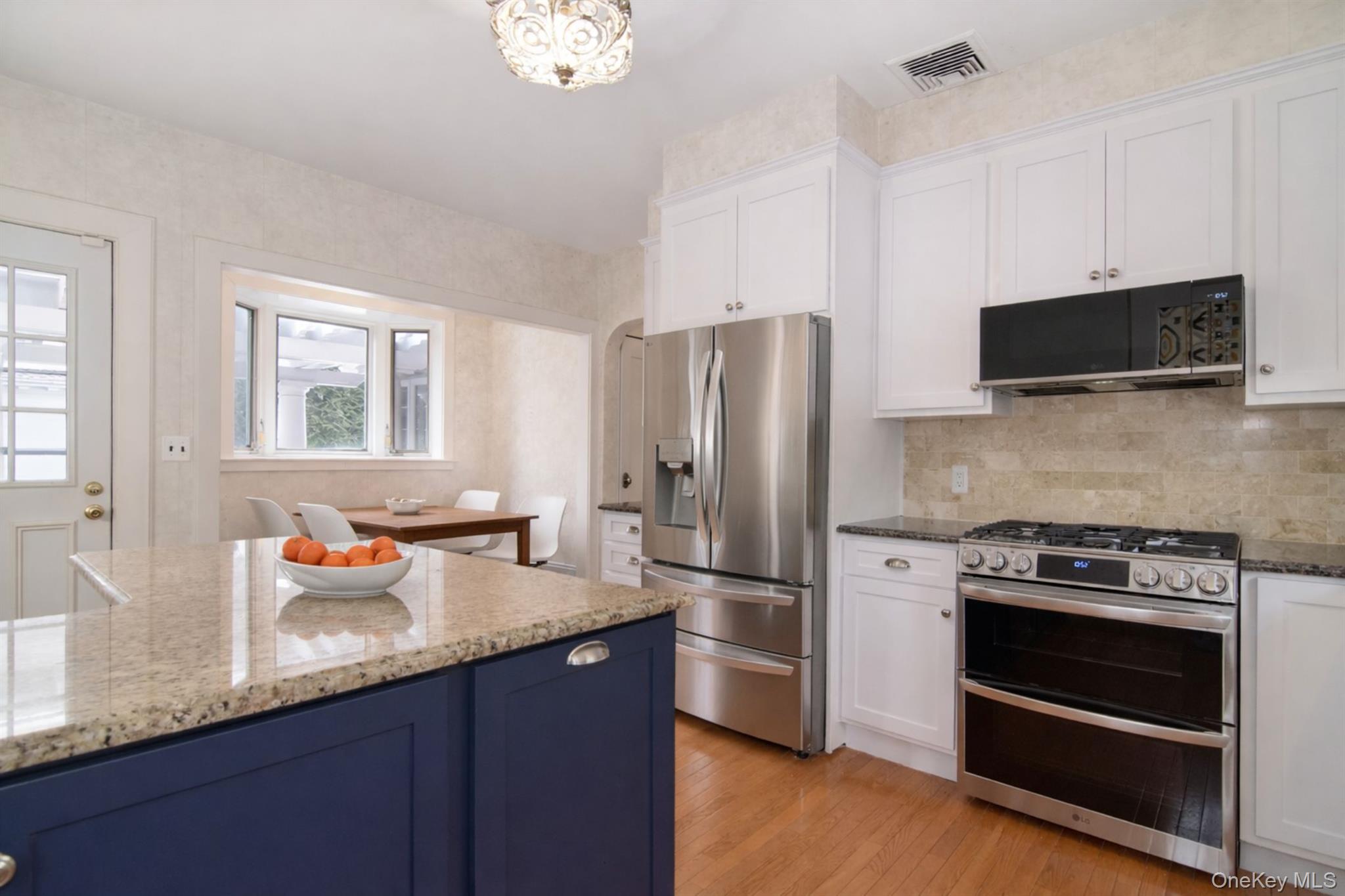 4610 Boston Post Road Pelham, NY 10803 - Photo 14 of 32 a kitchen with stainless steel appliances a stove microwave and refrigerator