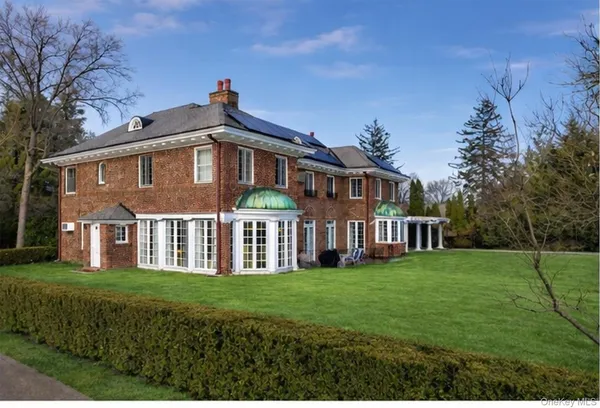 a front view of a house with a garden