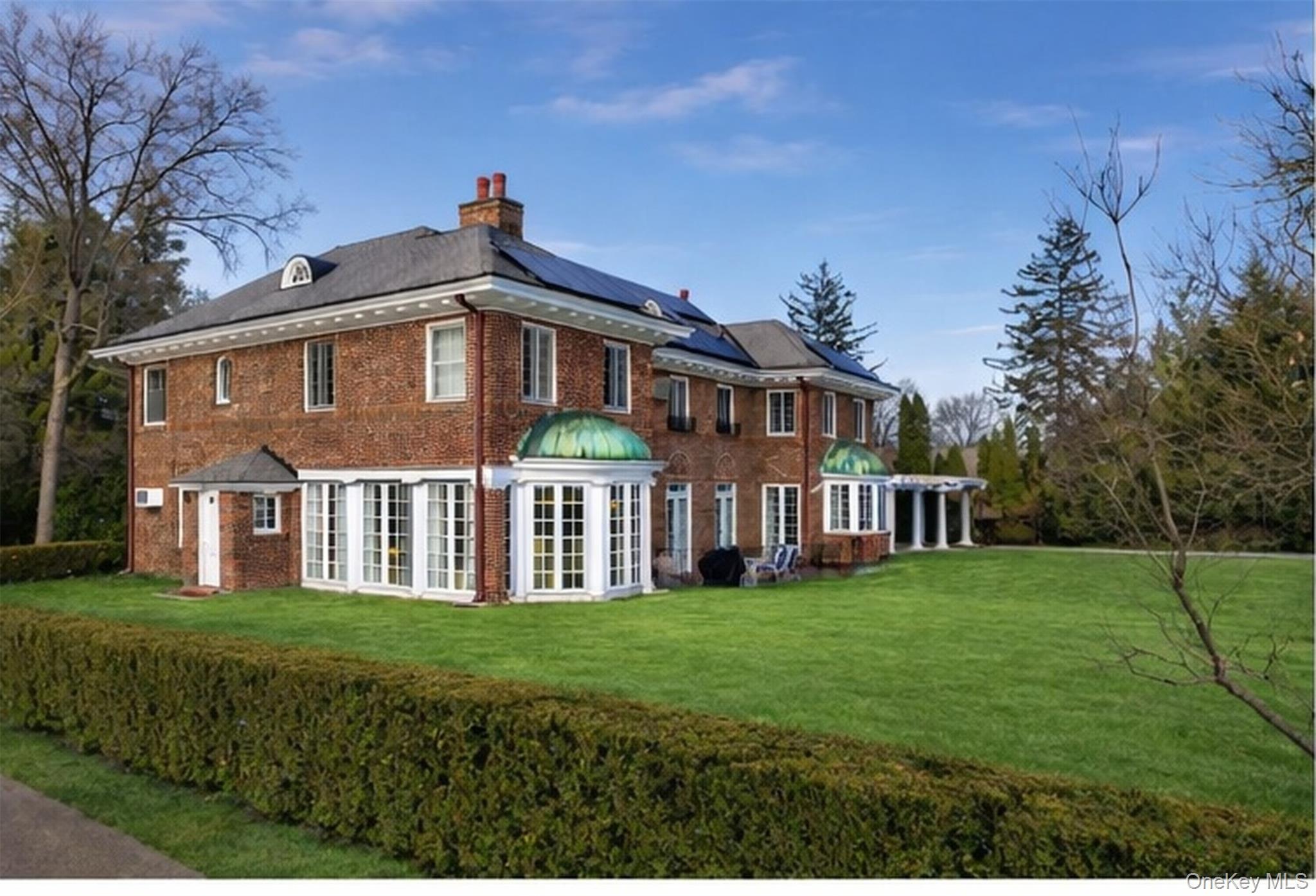 4610 Boston Post Road Pelham, NY 10803 - Photo 2 of 34 Rear view of property with roof mounted solar panels