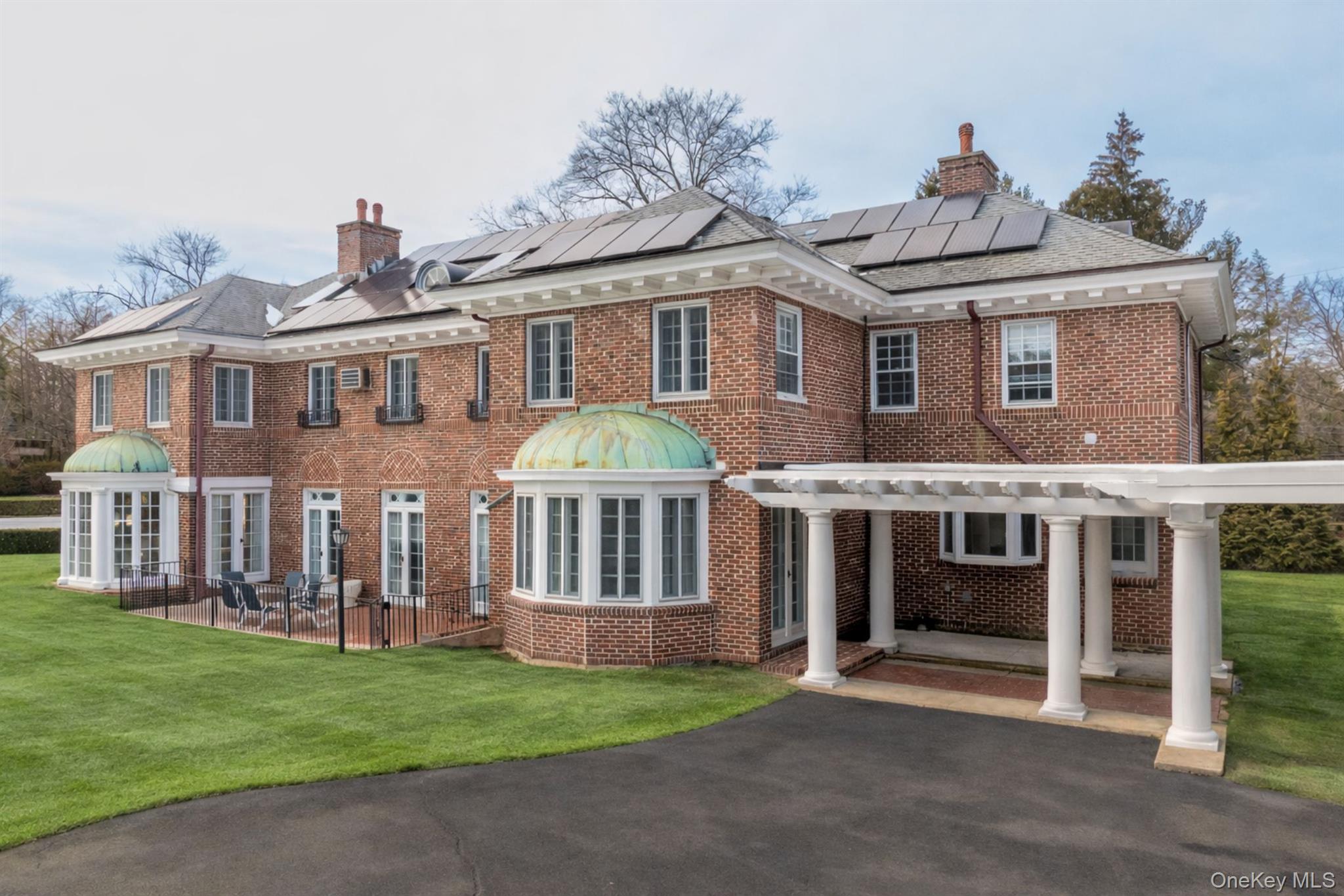 4610 Boston Post Road Pelham, NY 10803 - Photo 4 of 32 a front view of a house with a garden