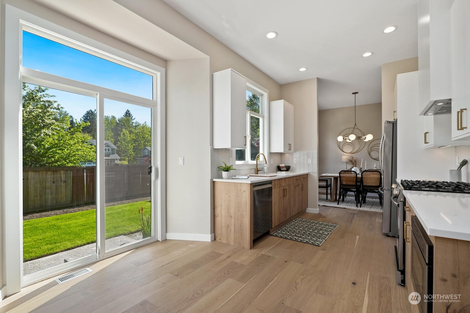 1332 237th Place Southwest Bothell, WA 98021 - Photo 12 of 29 a large white kitchen with a large window