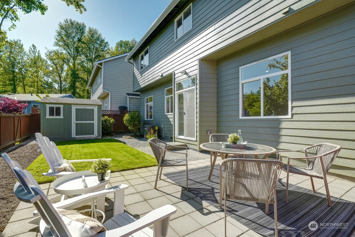 1332 237th Place Southwest Bothell, WA 98021 - Photo 27 of 29 a view of a patio with table and chairs and potted plants