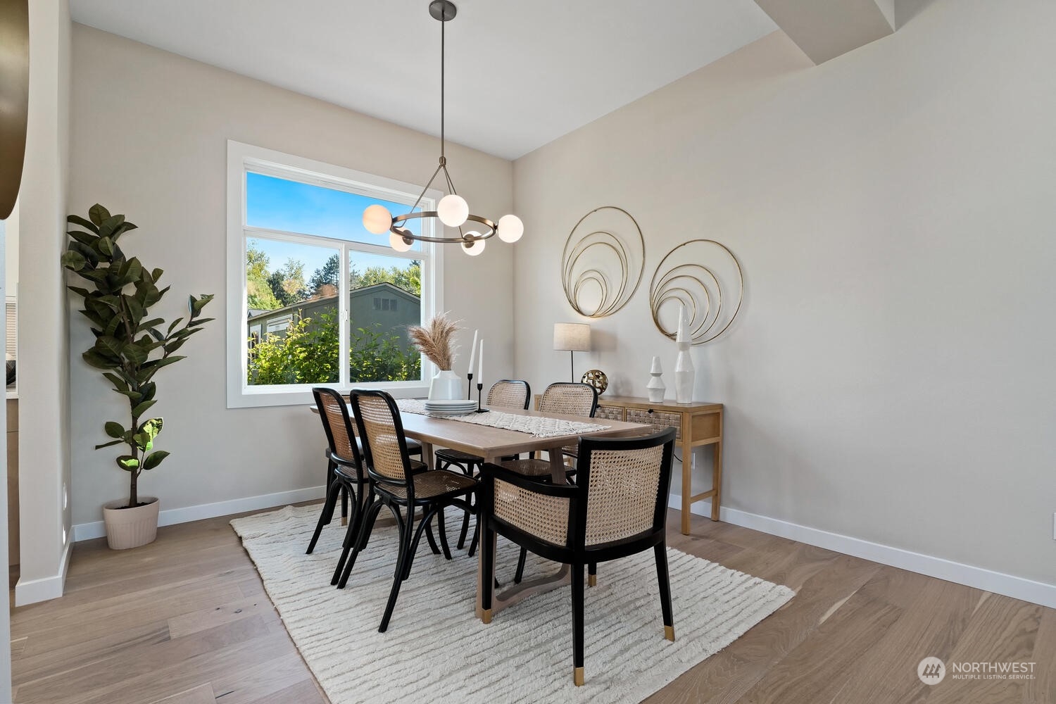 1332 237th Place Southwest Bothell, WA 98021 - Photo 7 of 29 a dining room with wooden floor a chandelier a wooden table and chairs