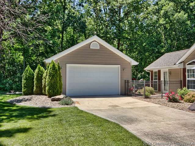 7841 Buttercup Road Weldon, IL 61882 - Photo 22 of 24 a front view of a house with a yard and potted plants