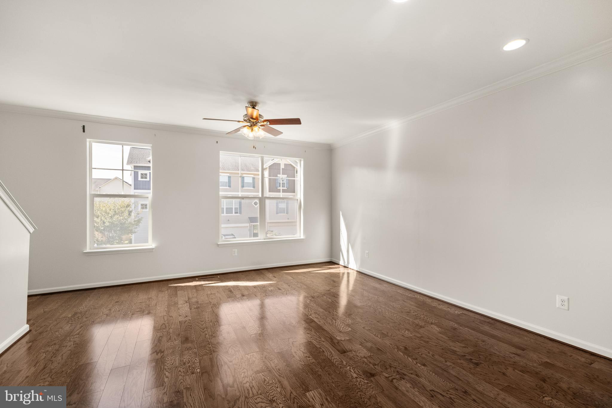 111 Rotunda Drive Stephenson, VA 22656 - Photo 14 of 33 an empty room with wooden floor and windows