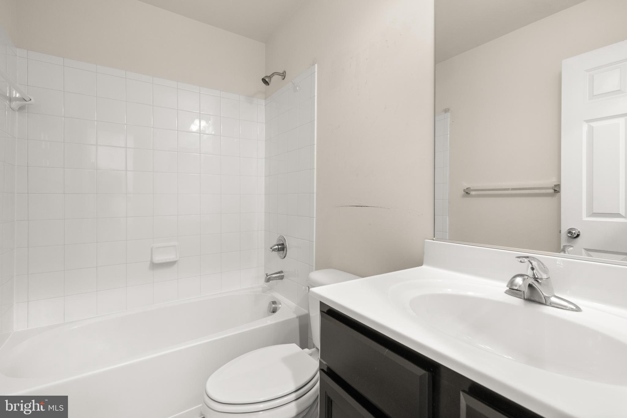 111 Rotunda Drive Stephenson, VA 22656 - Photo 24 of 33 a bathroom with a bathtub shower sink vanity mirror and toilet