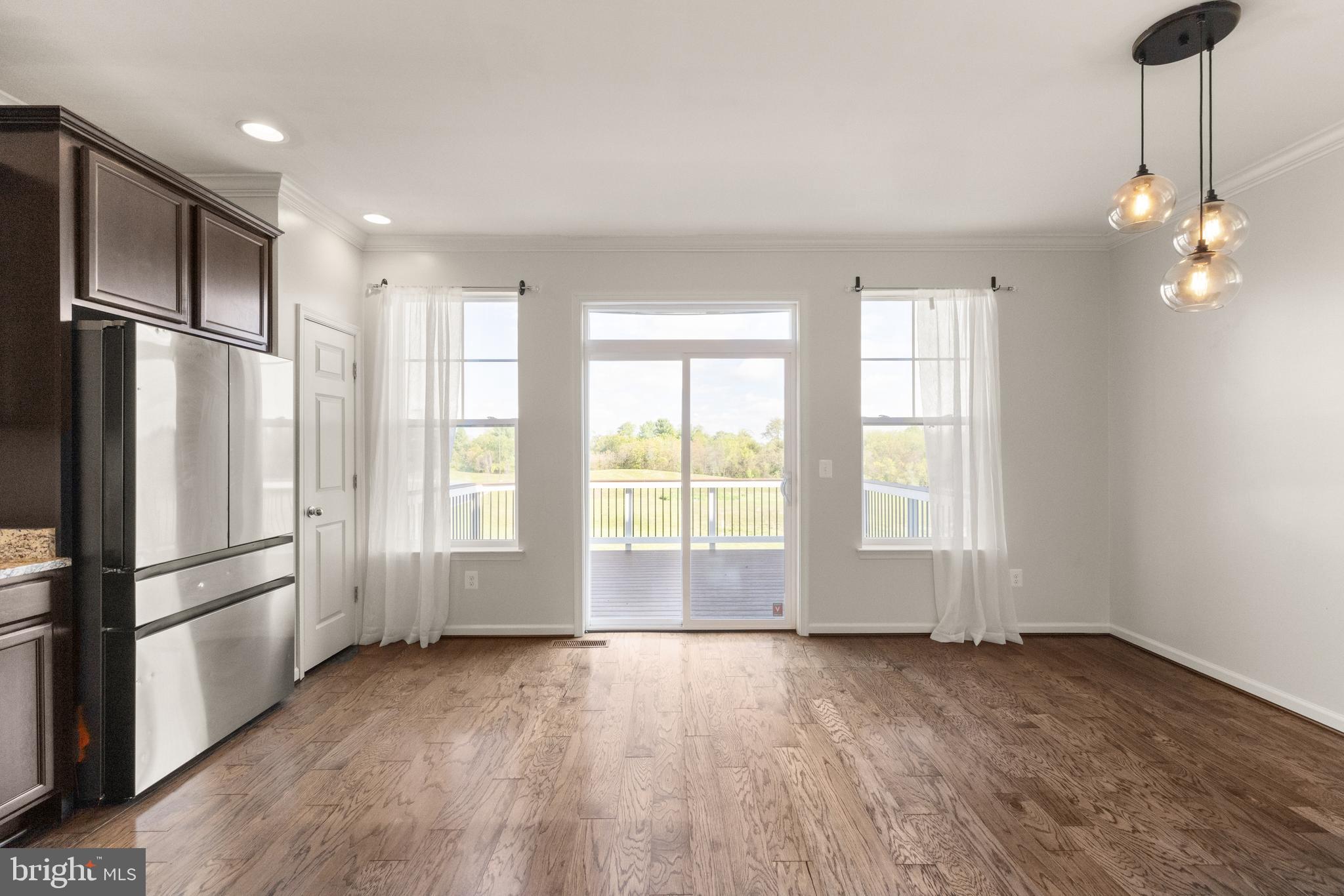 111 Rotunda Drive Stephenson, VA 22656 - Photo 8 of 33 a view of an empty room with a window and wooden floor