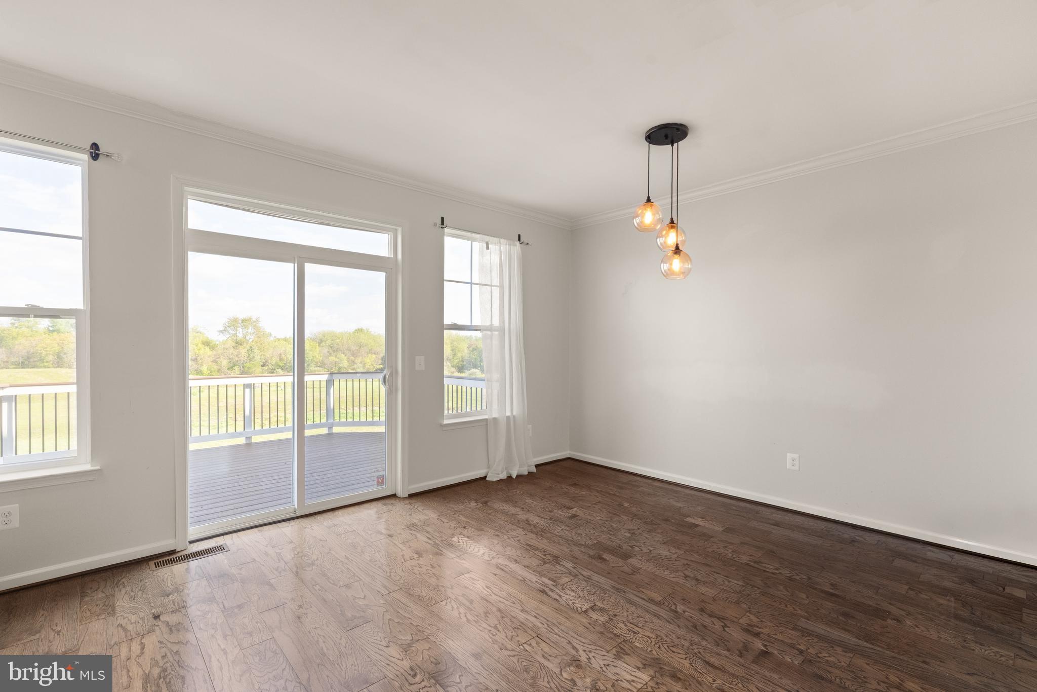 111 Rotunda Drive Stephenson, VA 22656 - Photo 9 of 33 an empty room with wooden floor and windows