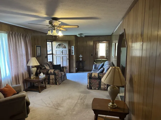 a living room with furniture and a chandelier