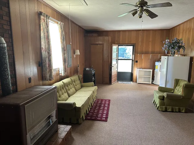 a living room with furniture and a chandelier