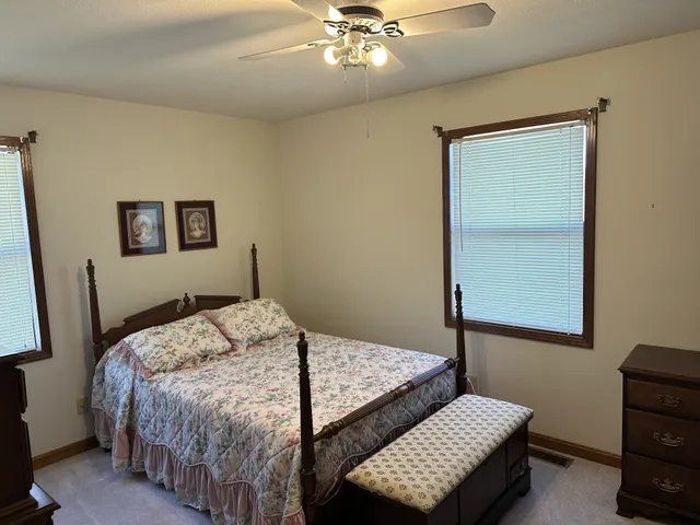 a bedroom with a bed and a dresser