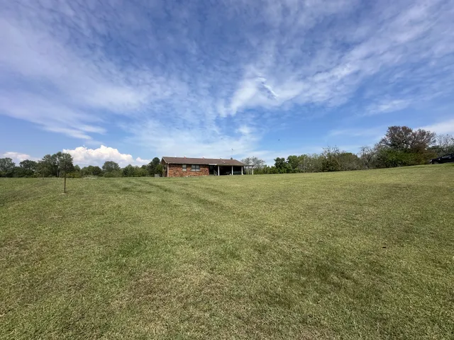a view of a field with ocean view