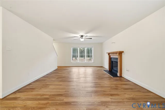 wooden floor in an empty room with a fireplace