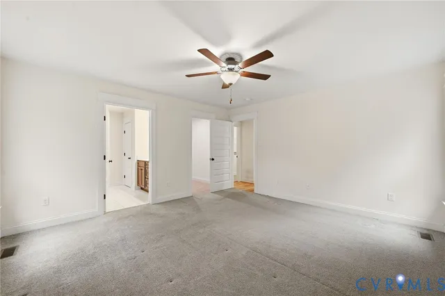 an empty room with closet and windows