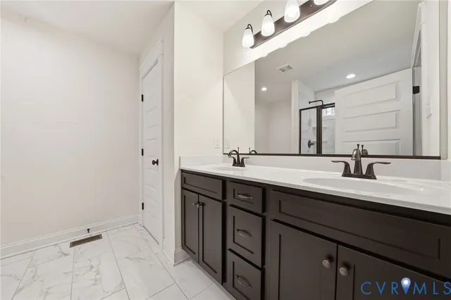 a bathroom with a double vanity sink mirror and