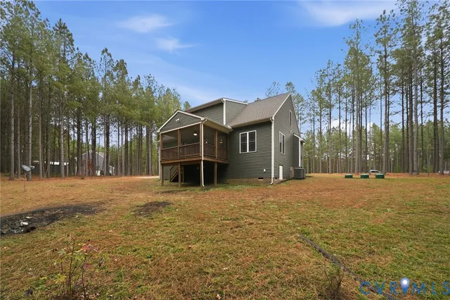 a view of a house with a yard and tree s