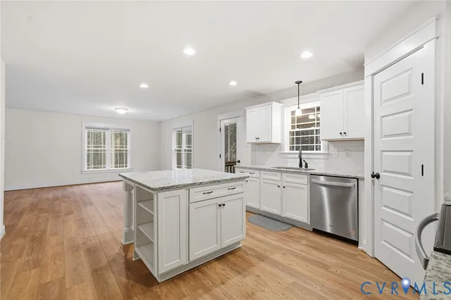 a kitchen with a stove a sink and a refrigerator