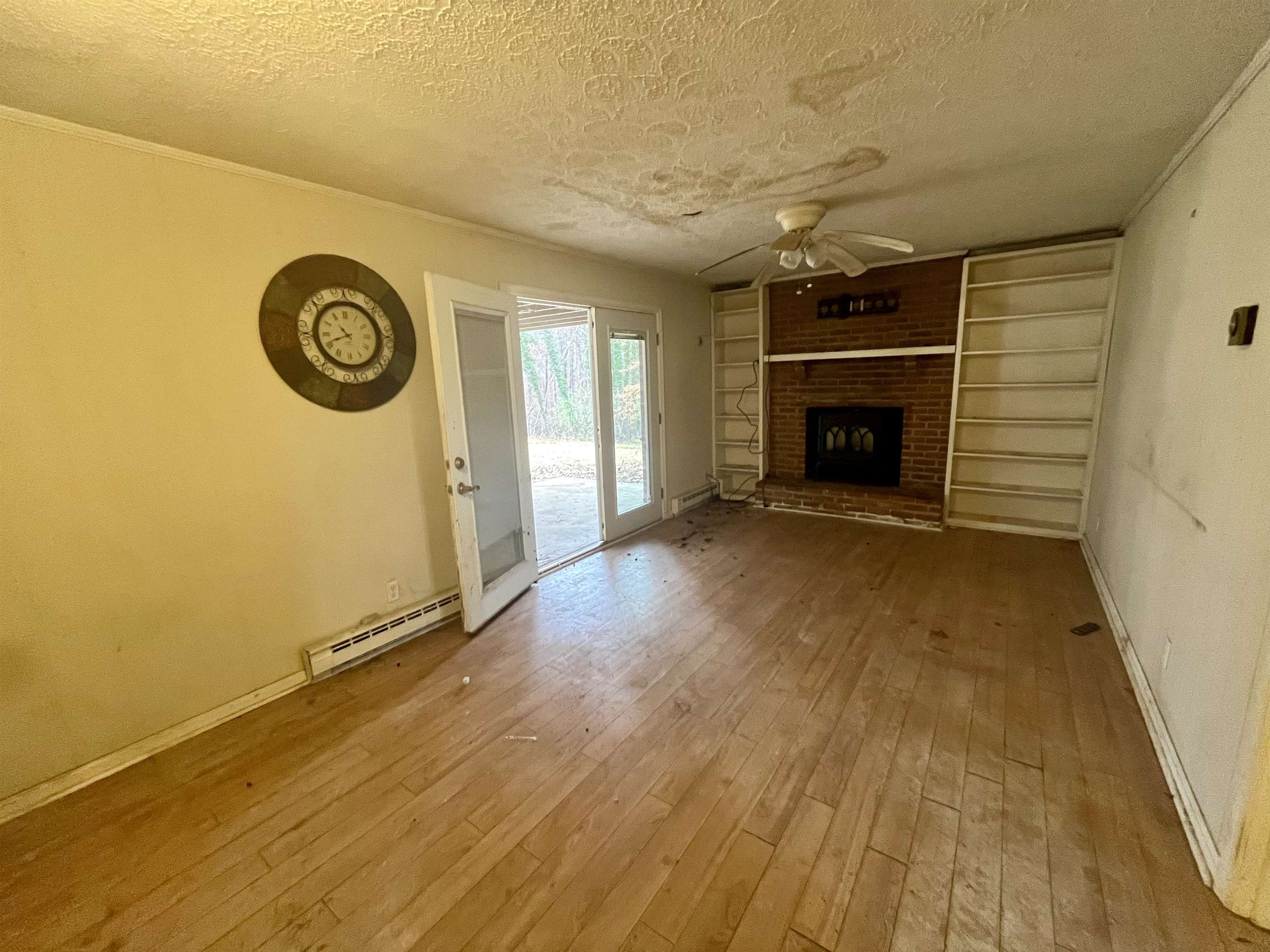 3672 Airport Acres Road Charlottesville, VA 22911 - Photo 29 of 49 a view of an empty room with a fireplace and a window