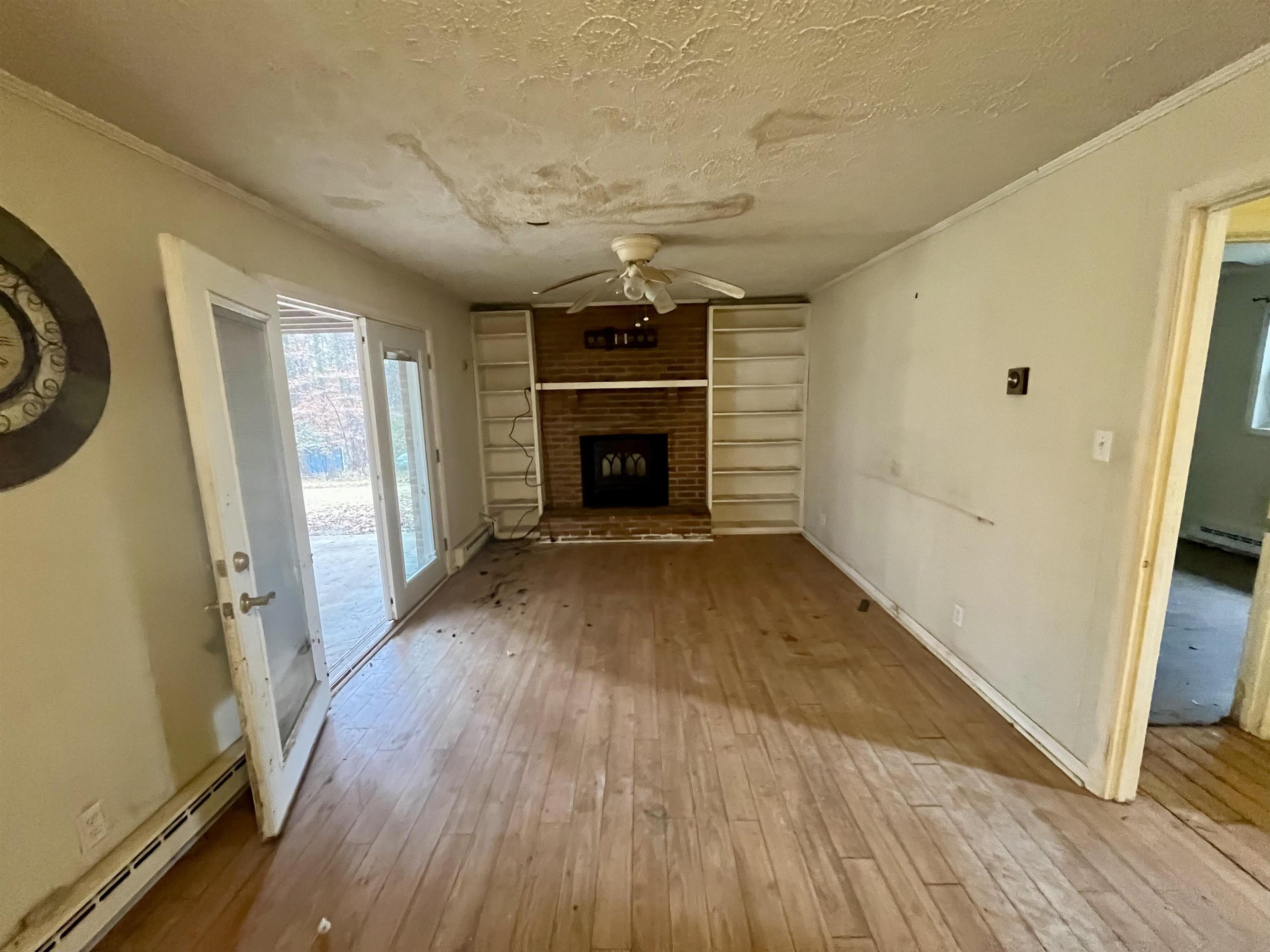 3672 Airport Acres Road Charlottesville, VA 22911 - Photo 31 of 49 wooden floor in an empty room with a fireplace