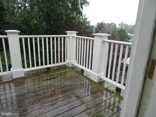 a view of a balcony with wooden fence and floor