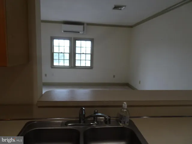 a kitchen with a sink and a refrigerator