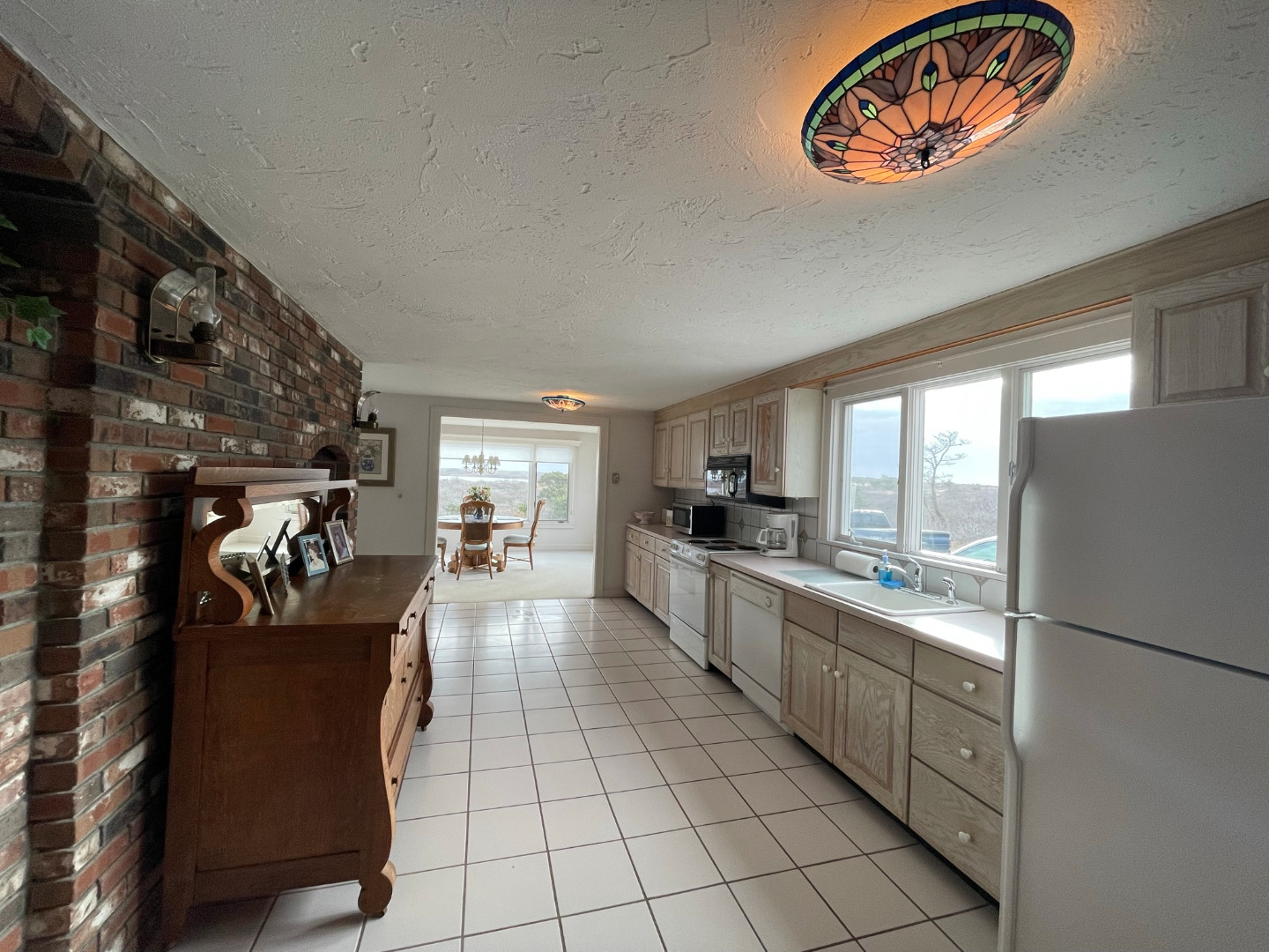 118 Eel Point Road Nantucket, MA 02554 - Photo 12 of 16 a kitchen with stainless steel appliances granite countertop a refrigerator and a stove top oven