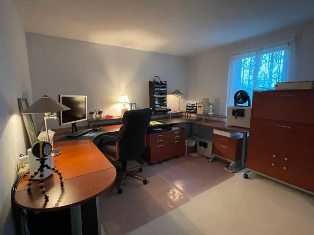 a bedroom with a bed and a refrigerator