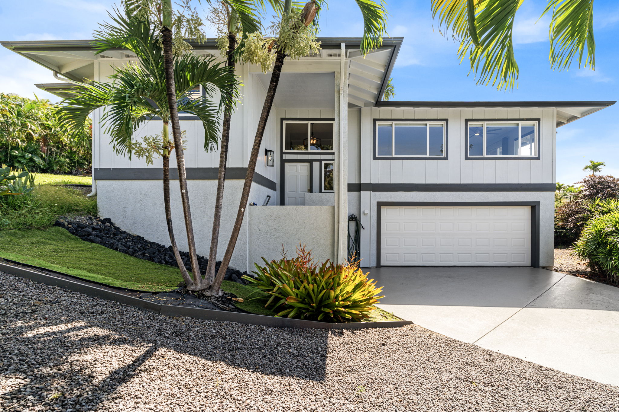 a front view of a house with a garden
