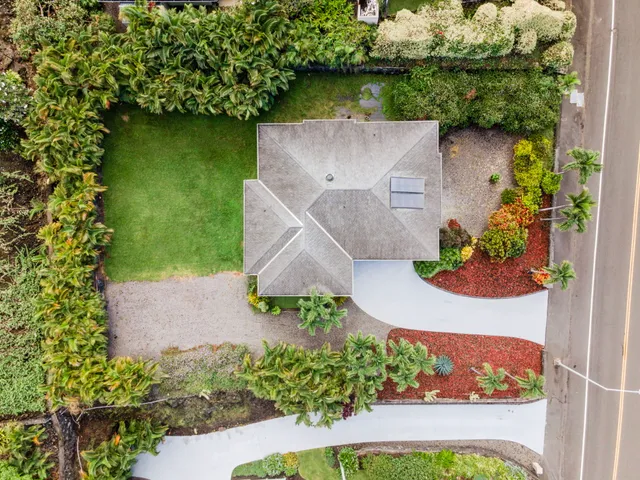 an aerial view of a house with a yard and garden