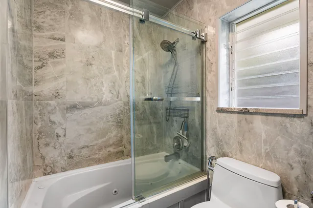 a bathroom with a shower and a toilet