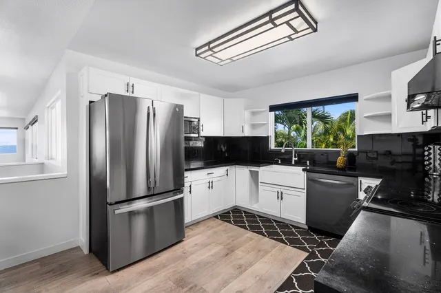 a kitchen with a refrigerator stove and sink