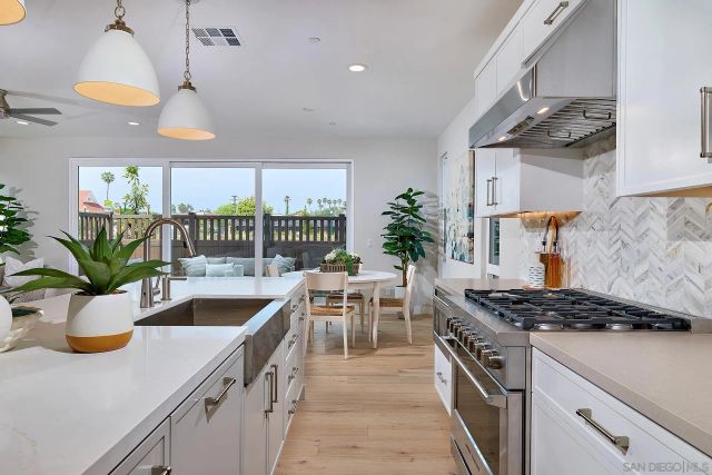 a kitchen with a stove and a white cabinets