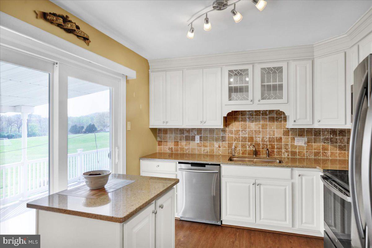 112 Brown Street Reading, PA 19606 - Photo 13 of 32 a kitchen with stainless steel appliances granite countertop a sink a stove and a white refrigerator