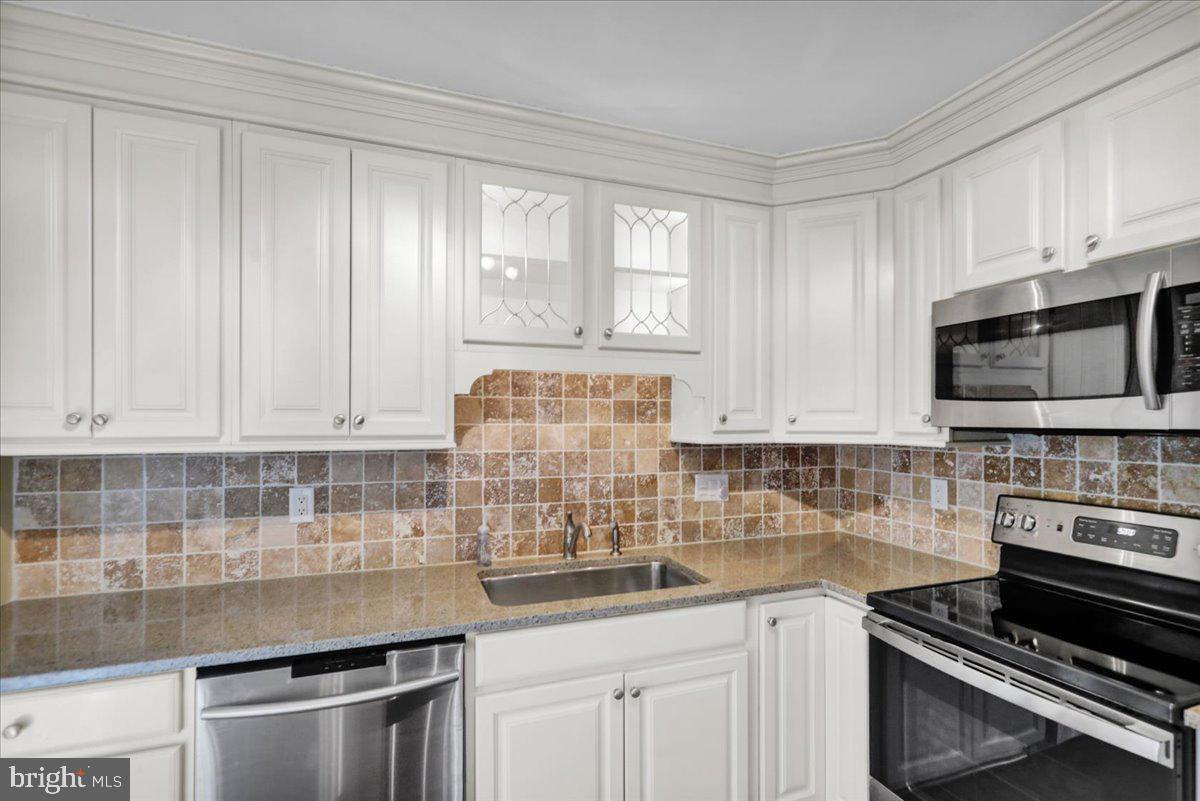 112 Brown Street Reading, PA 19606 - Photo 14 of 32 a kitchen with stainless steel appliances a sink stove and microwave