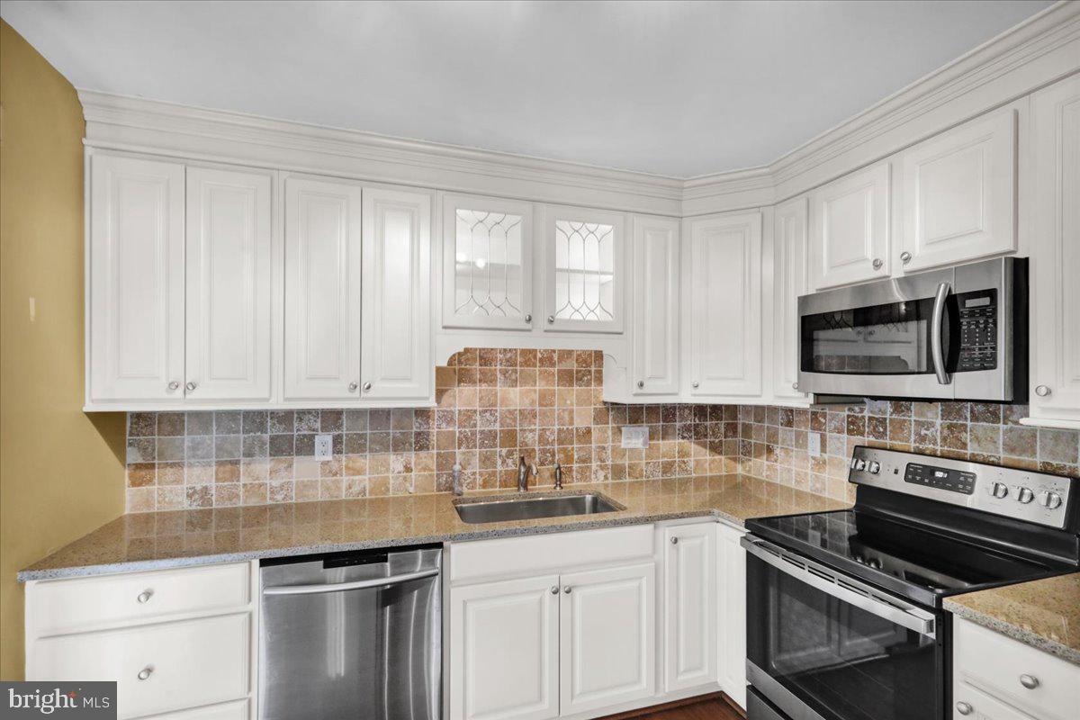 112 Brown Street Reading, PA 19606 - Photo 15 of 32 a kitchen with stainless steel appliances granite countertop a sink stove and microwave
