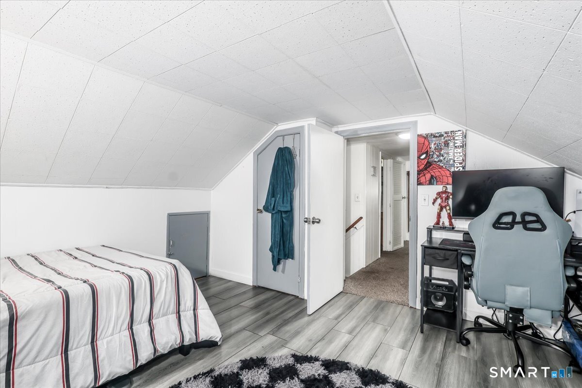 306 Welton Street Hamden, CT 06517 - Photo 23 of 38 a bedroom with a bed and wooden floor