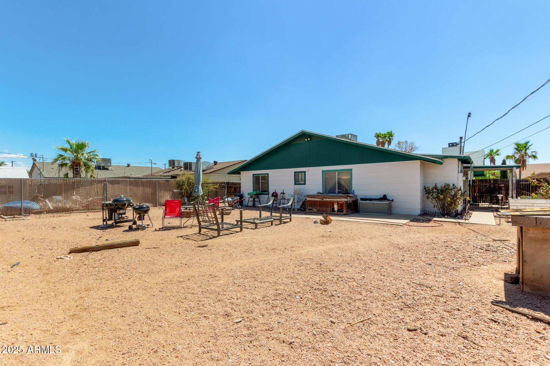 538 East Fred Avenue Apache Junction, AZ 85119 - Photo 18 of 20 a view of a patio with a table and chairs under an umbrella
