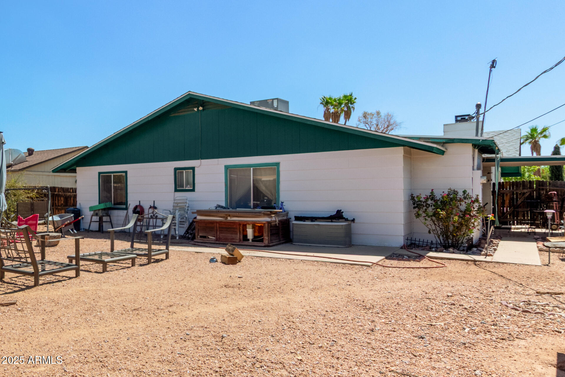 538 East Fred Avenue Apache Junction, AZ 85119 - Photo 19 of 20 a view of a patio with a table and chairs under an umbrella