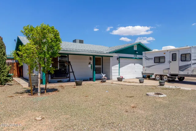 a view of a house with a patio and a yard