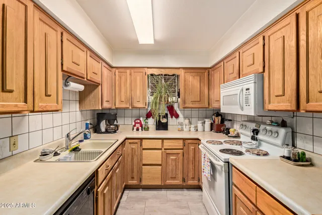 a kitchen with a sink stove top oven and cabinets
