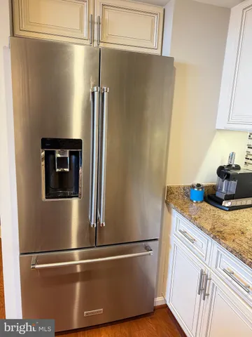 a view of a refrigerator in kitchen and stainless steel appliances