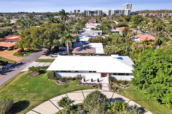 an aerial view of residential houses with outdoor space and street view