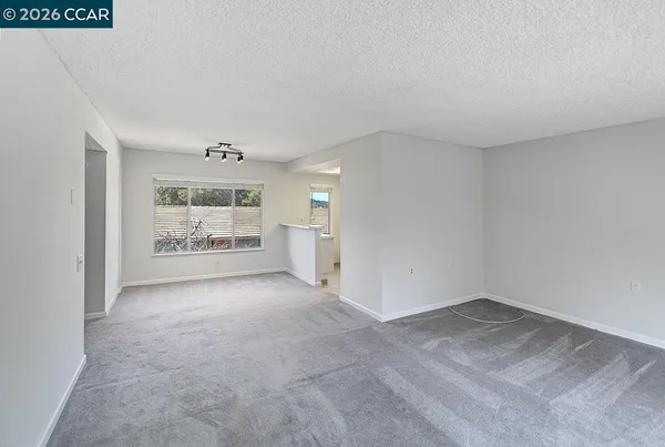 an empty room with windows and closet