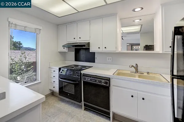 a kitchen with a stove and a refrigerator