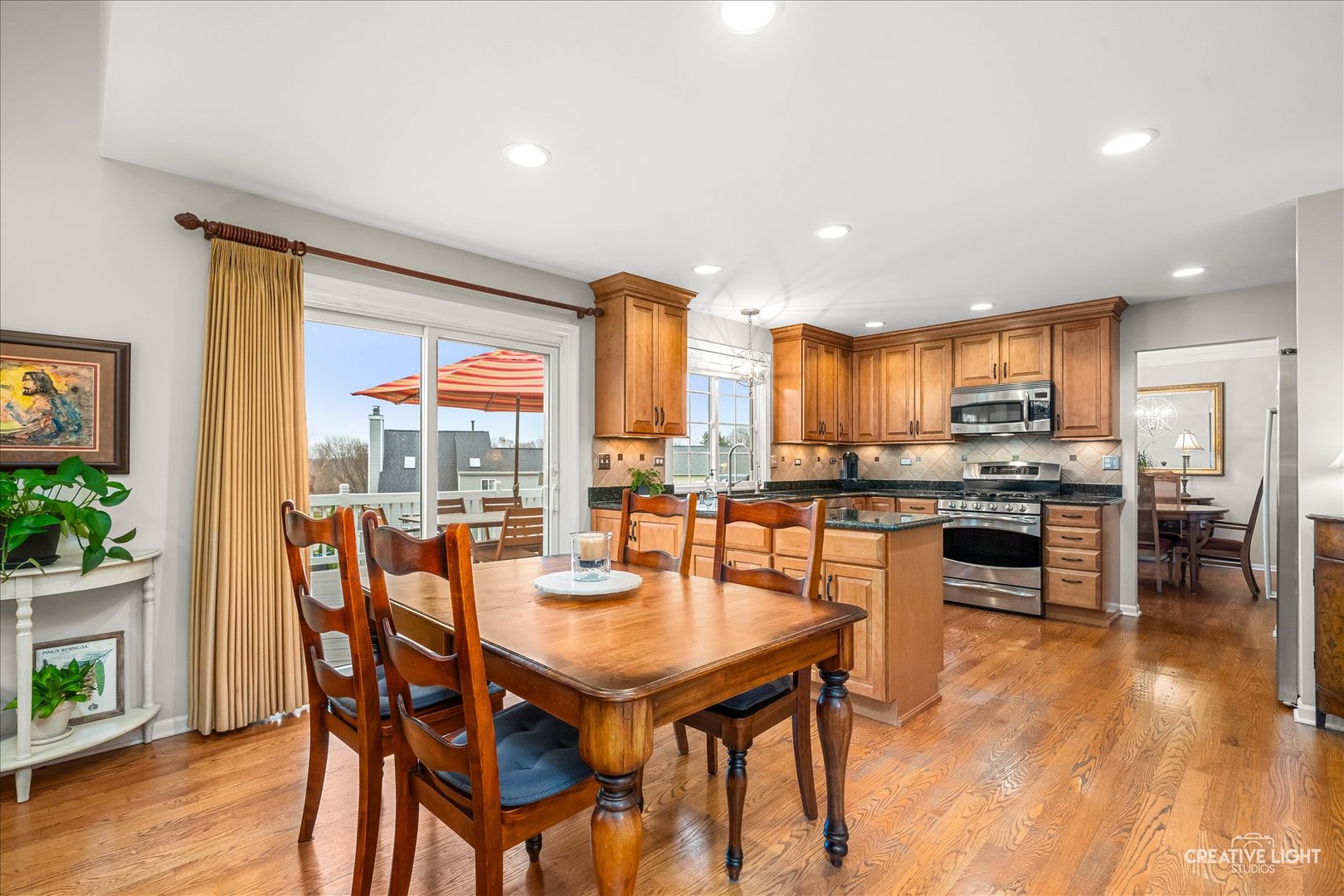 7 Falcon Ridge Court Algonquin, IL 60102 - Photo 17 of 51 a dining hall with stainless steel appliances kitchen island granite countertop a table and chairs with wooden floor