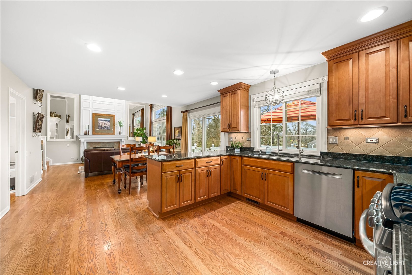 7 Falcon Ridge Court Algonquin, IL 60102 - Photo 9 of 51 a kitchen with stainless steel appliances granite countertop wooden cabinets a dining table and chairs