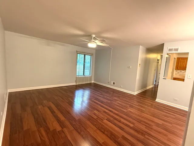 a view of a room with wooden floor and window