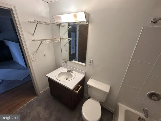 a bathroom with a toilet sink and mirror