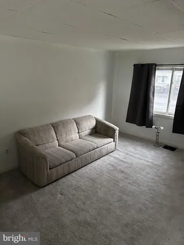 a living room with furniture and window