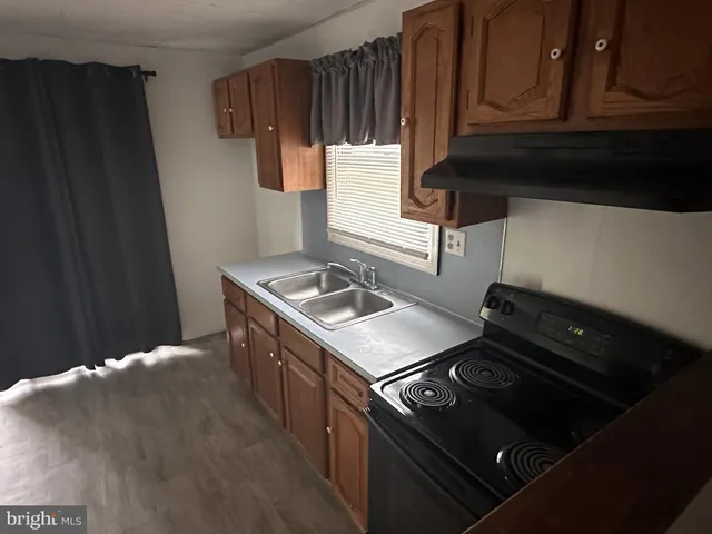 a stove top oven sitting inside of a kitchen
